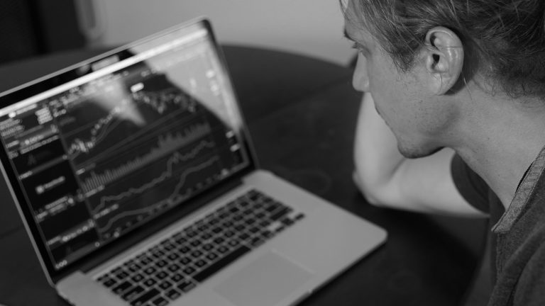 Price charts on a laptop screen showing how crypto trading bots work