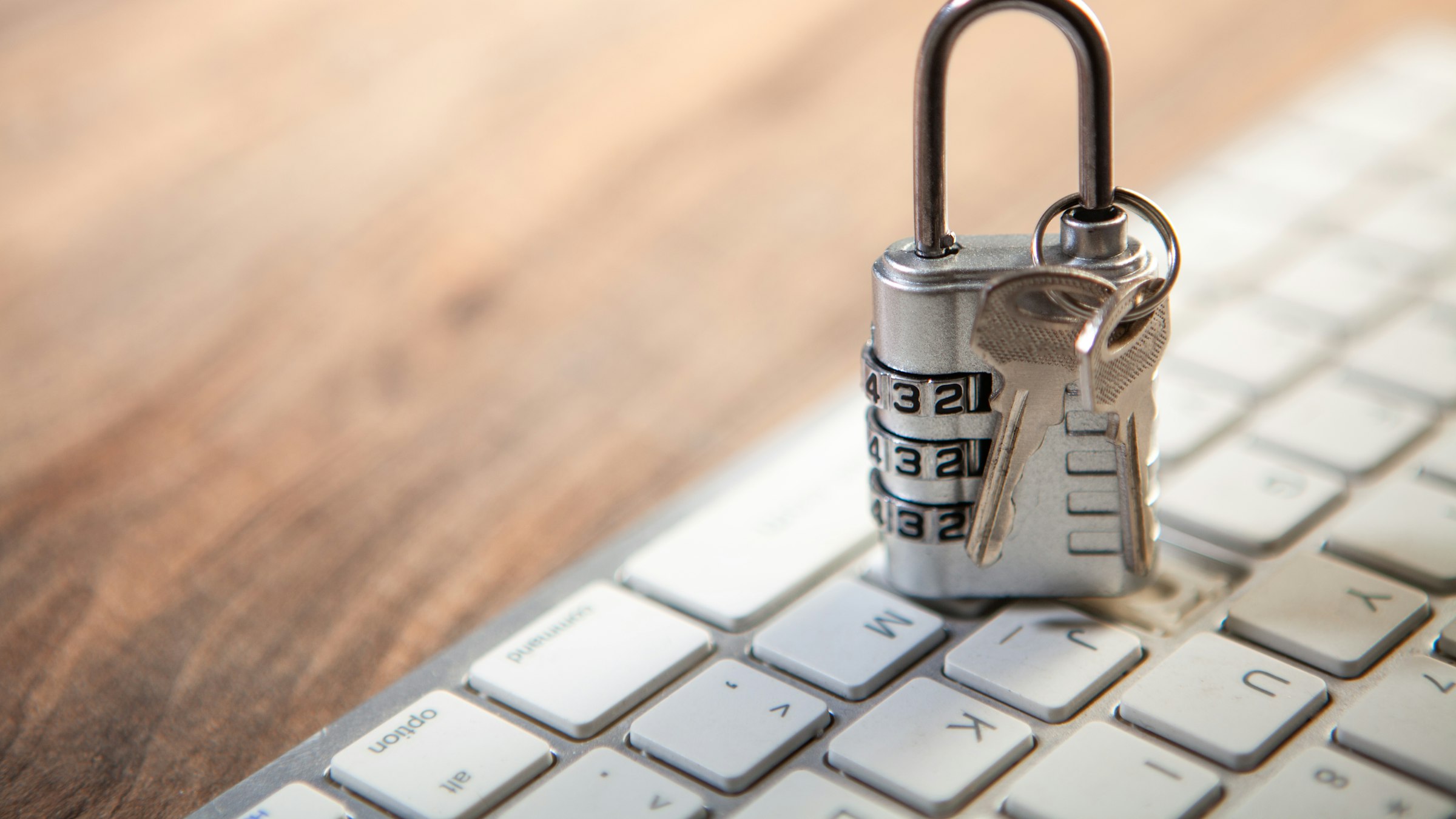 Padlock and keys on a computer keyboard, illustrating the question is 3Commas safe