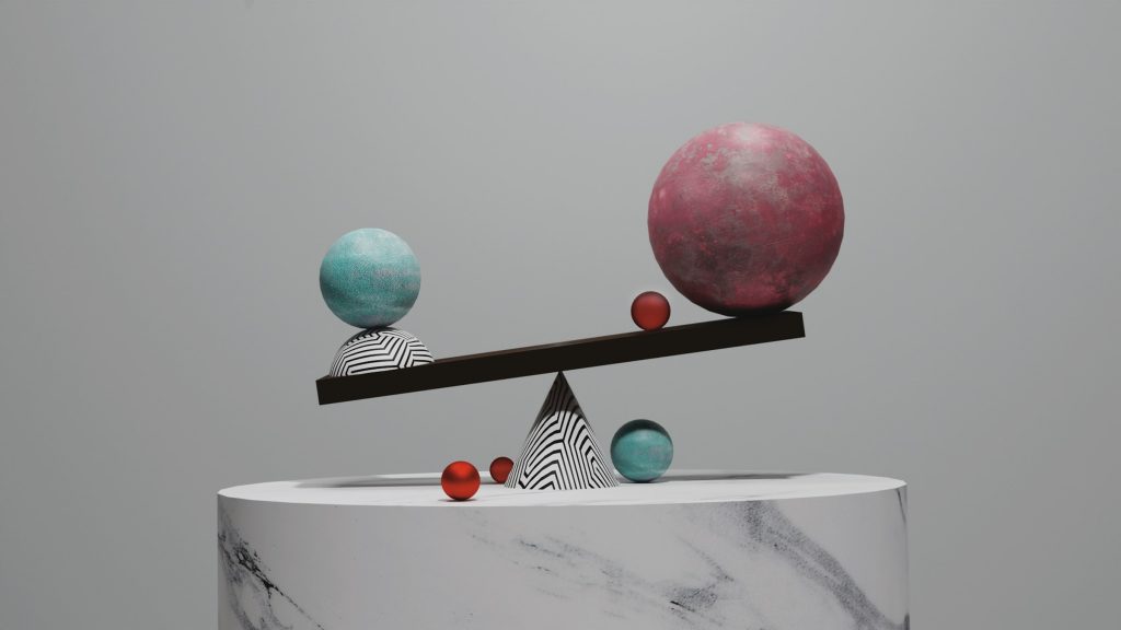 Balance scale with spheres on marble, a picture of position sizing crypto risk