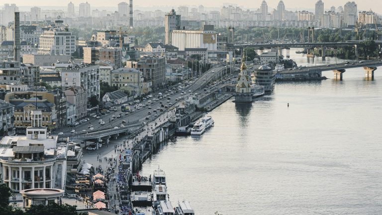 The Dnipro River embankment in Kyiv with the city skyline