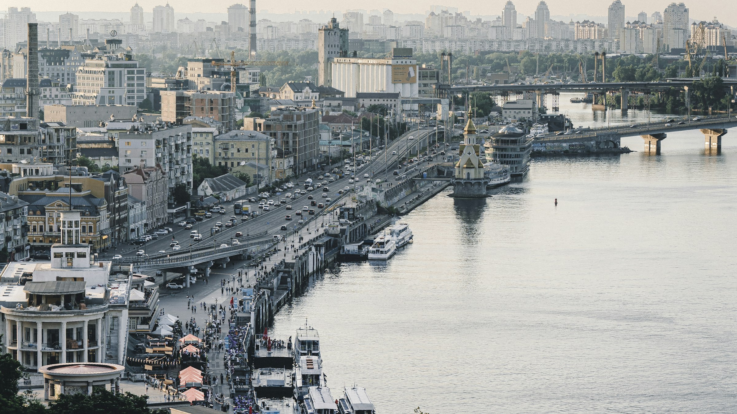 The Dnipro River embankment in Kyiv with the city skyline